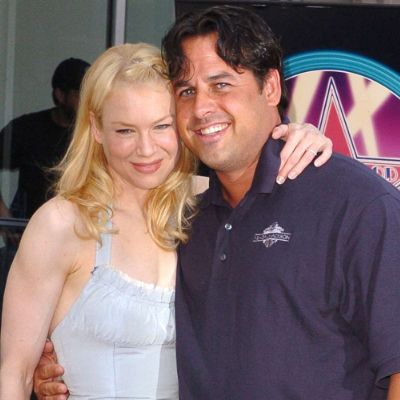 They are both holding each other as they are smiling.